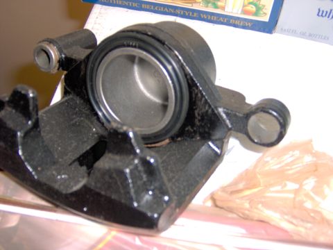 1993 Ford Probe - Close-up of a black brake caliper part, likely for a car.