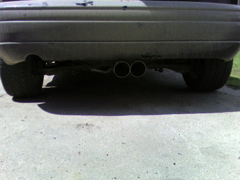 Rear bumper and dual exhaust pipes of a car
