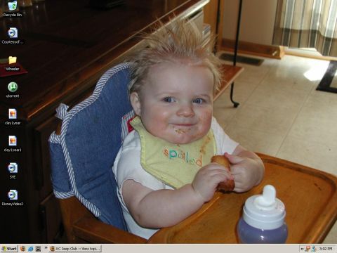 1998 Jeep TJ - A baby with a messy face and spiky hair sits in a high chair, wearing a bib that says "spoiled" and holding a cracker.