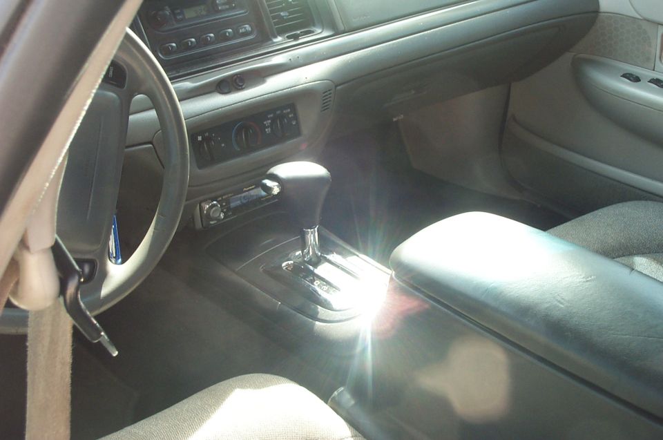 Crown Victoria interior with gray dash, floor-shift center console, and aftermarket Pioneer stereo