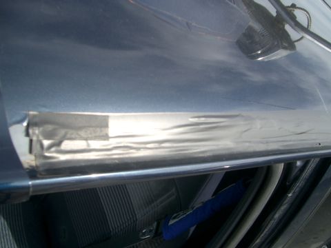 1992 Ford Ranger - A piece of silver tape is applied to the interior trim of a vehicle.