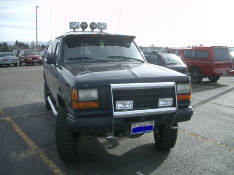 1992 Ford Ranger - A black Ford Explorer is parked in a lot, showing its front end with custom accessories.