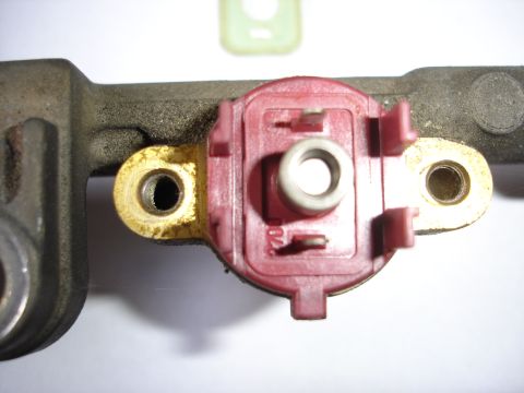 1993 Mazda MX-3 - Fuel rail component with a red sensor, showing some wear and residue.