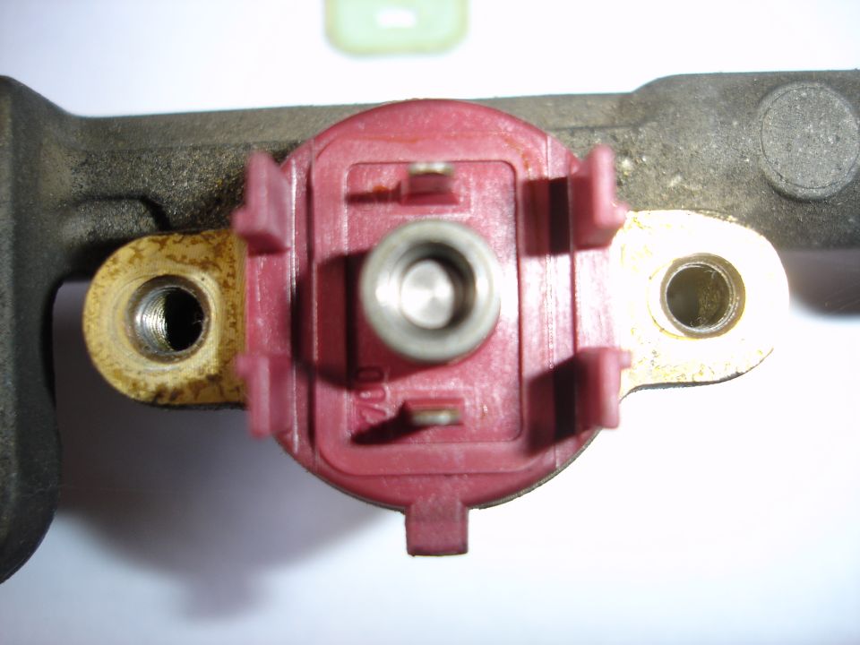 Macro top view of red coil module with metal terminal in cast aluminum housing