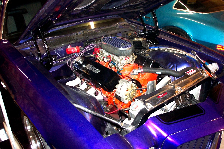 Purple 1970 Chevrolet Camaro engine bay with orange V8 engine, chrome details, and air filter