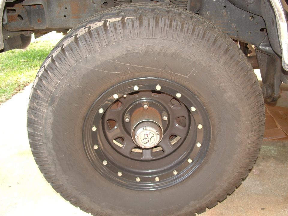 Close-up of a black wheel with a BFGoodrich tire. Hub has a "4x4" logo