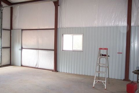 1986 Ford Ranger - The interior of a metal building, possibly a garage or workshop, is shown with construction materials and tools.