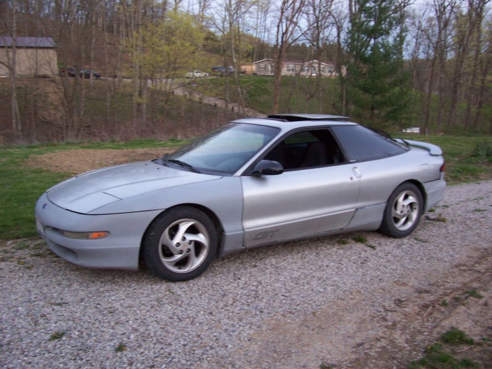 Silver 1996 Ford Probe coupe with a sunroof and aftermarket wheels
