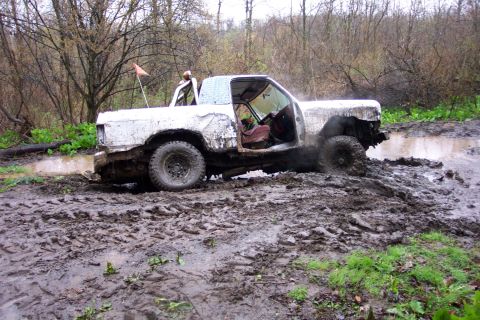 1978 Ford Bronco - This off-road pickup truck is deeply stuck in a muddy, wooded area.