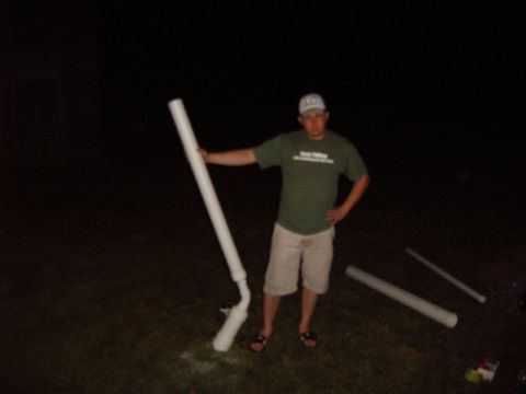 1988 Ford Bronco - A man stands with a large white pipe in a dark outdoor setting.
