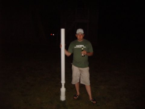 1988 Ford Bronco - A man stands in the dark holding a long white pipe and a bottle.