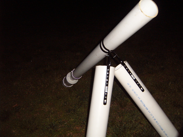 DIY telescope constructed from PVC pipes, with visible text on one pipe
