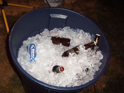 1988 Ford Bronco - A large blue trash can is filled with ice and several bottles of beer, along with a can of Bud Light.