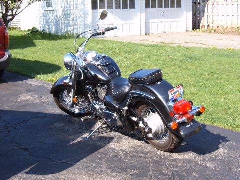 1993 Ford Bronco - A black cruiser motorcycle is parked on an asphalt driveway in front of a garage.