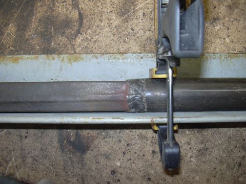 1991 Ford Bronco - A metal tube is clamped to a workbench, showing a recent weld repair.