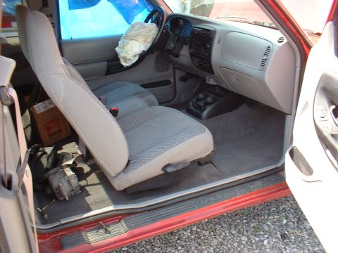 1999 Ford Ranger - Interior view of a 1999 Ford Ranger, showing damage to the driver's side and deployed airbag.