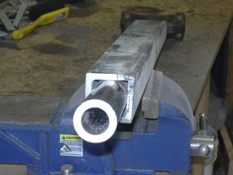 1991 Ford Bronco - A metal tube is secured in a vise, ready for work. A caution sticker is visible on the vise.