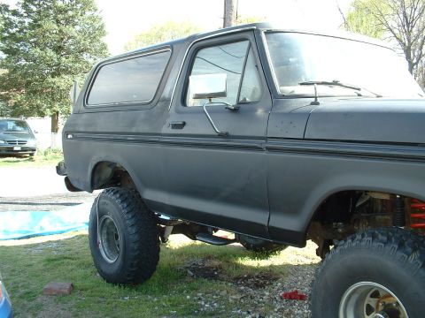 1978 Ford Bronco - This 1978 Ford Bronco features a matte black finish and an aggressive lifted stance with oversized off-road tires.