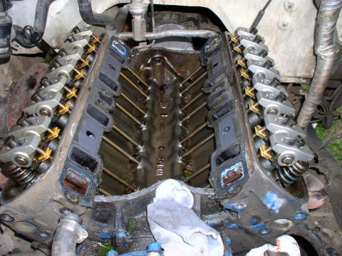 1988 Ford Bronco - Close-up view of a V8 engine's cylinder heads with the intake manifold removed, revealing internal components.