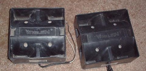 1997 Ford Crown Victoria - Two Whelen siren speakers are shown, each with visible wiring and mounting screws.