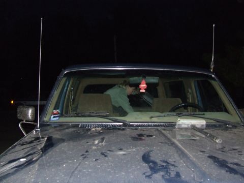 1986 Ford Bronco - A person is visible inside the vehicle, reaching towards the dashboard.