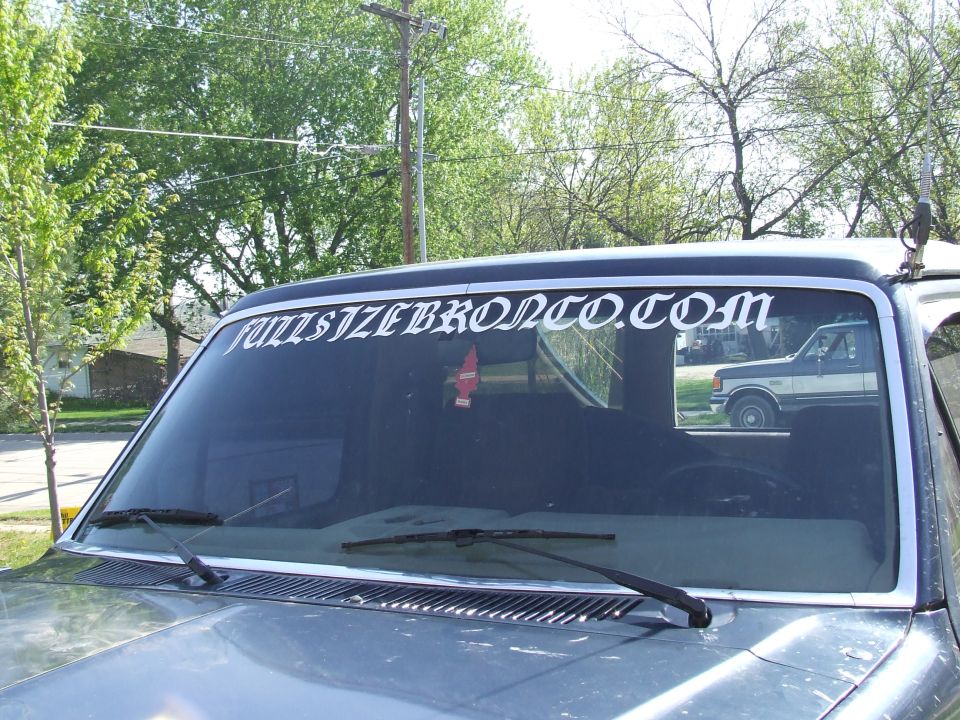 Windshield banner reads FULLSIZEBRONCO.COM; reflection shows a 1987 Ford F-150