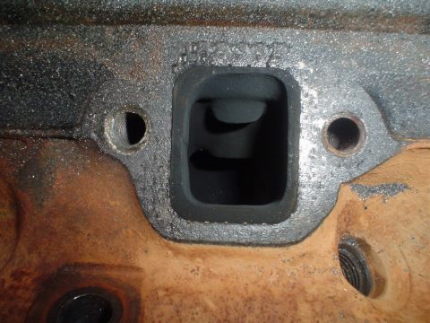 1984 Ford Bronco - This image shows a close-up of an engine exhaust port, not a 1984 Ford Bronco.