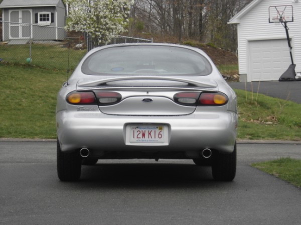 Rear view of a 1999 Ford Taurus with a spoiler and dual exhaust pipes