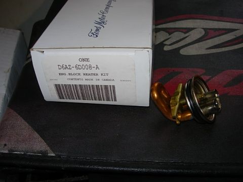 1993 Ford Bronco - A Ford Motor Company engine block heater kit is shown next to its component parts.