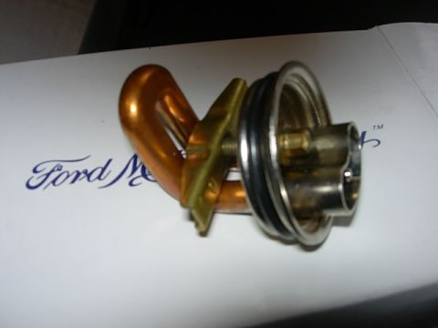 1993 Ford Bronco - A block heater part is shown on a surface with a Ford logo and Supermotors.net watermark.