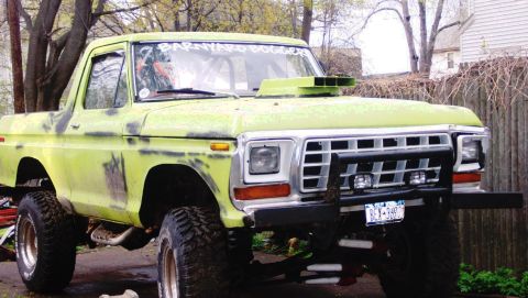 1978 Ford Bronco - This lifted pickup truck features a prominent hood scoop and a custom paint job with visible primer patches.