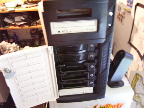 1994 Ford Probe - A computer tower with its front panel open, revealing multiple drive bays and a CD-ROM drive.