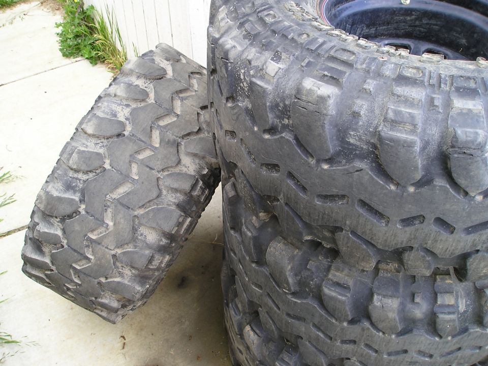 Stack of off-road tires with aggressive tread patterns