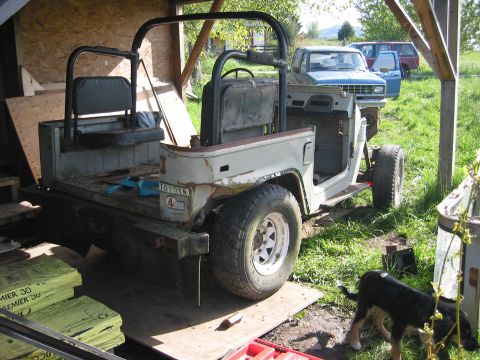 1991 Ford Explorer - This Toyota Land Cruiser FJ40 is undergoing some work, with other vehicles parked nearby.