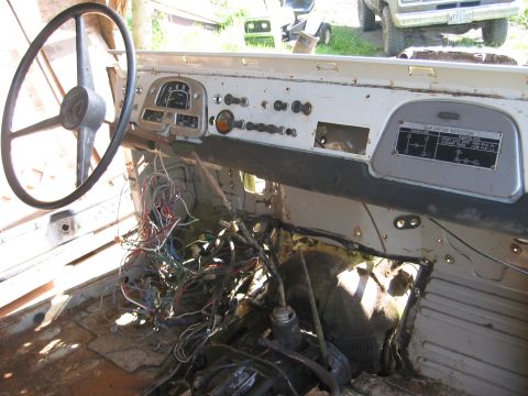 1991 Ford Explorer - The interior of a vehicle shows exposed wiring, a steering wheel, and a dashboard with a gear-shifting instruction plate.