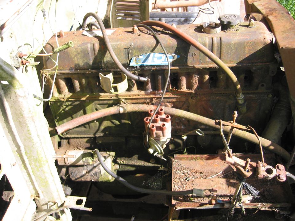 Rusty engine with distributor cap and spark plug wires