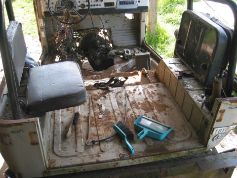 1991 Ford Explorer - Interior of a vehicle undergoing disassembly and cleaning, with tools scattered on the floor.