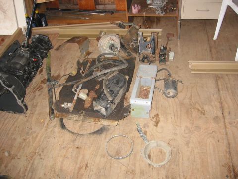 1991 Ford Explorer - Collection of engine and vehicle components laid out on a plywood surface.