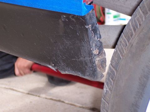 1972 Ford Ranchero - Close-up of a damaged vehicle quarter panel, showing wear and tear.
