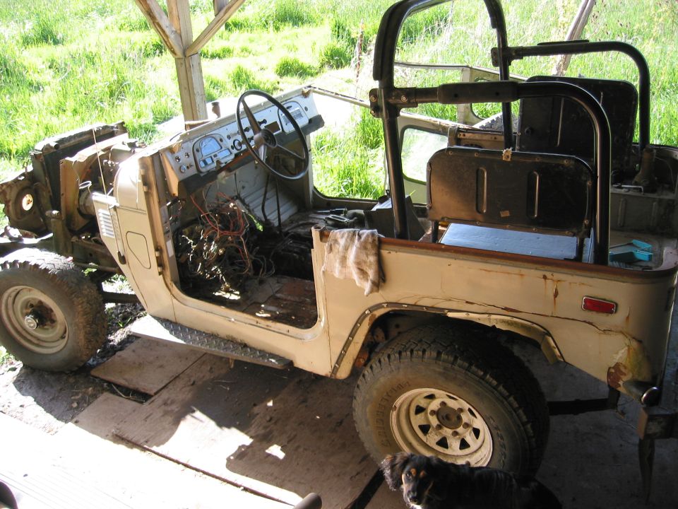 Toyota Land Cruiser FJ40 body with no doors, engine exposed, and interior visible