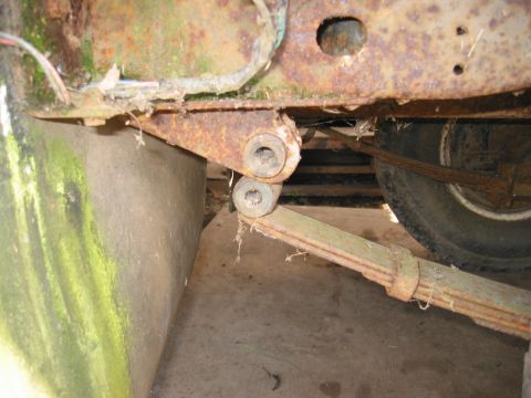 1991 Ford Explorer - Close-up view of a rusty leaf spring and suspension components, with a tire in the background.
