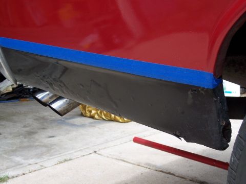 1972 Ford Ranchero - Lower quarter panel repair on a vehicle, showing taped area and exhaust pipes.