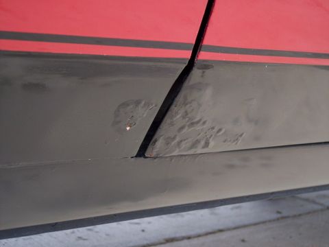 1972 Ford Ranchero - Bubbling paint indicates rust forming on the lower body panel of a vehicle.