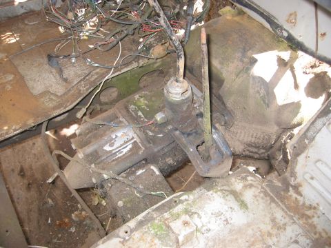 1991 Ford Explorer - Close-up of a vehicle's transmission and a messy wiring harness, suggesting disrepair.