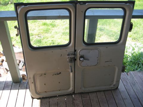1991 Ford Explorer - These are a pair of vehicle doors with windows and handles, likely for an older SUV or truck.