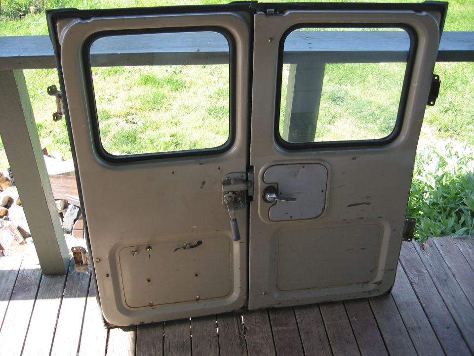 Pair of tan vehicle doors with square windows and chrome handles