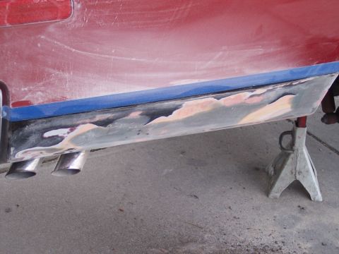 1972 Ford Ranchero - The vehicle's lower body panel is undergoing repair work, with primer and filler applied.