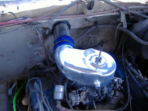 1979 Ford Bronco - Engine bay detail showing a chrome air intake assembly with blue hose clamps.