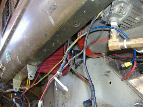 1979 Ford Bronco - Close-up view of engine bay wiring and components, with a red and gray canister labeled 'EXTREME'.