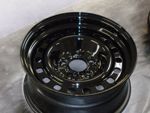 1996 Ford Crown Victoria - A close-up shot of a newly painted black steel wheel rim.